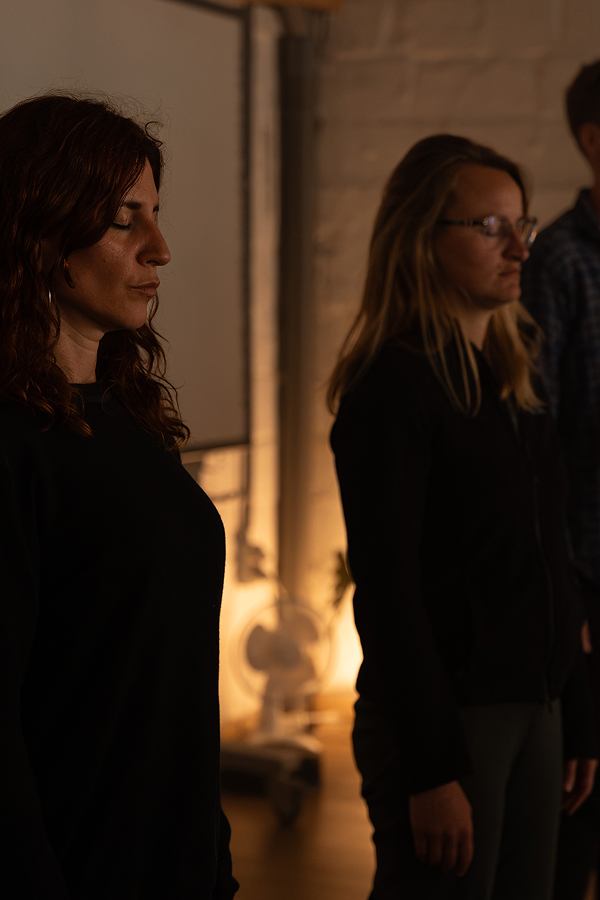 Two employees relax and chat at a corporate team-building event after work.