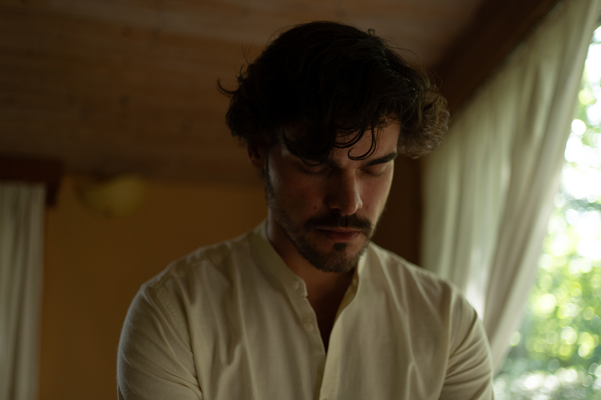 Portrait of a man in deep contemplation, representing the journey of inner connection and self-acceptance